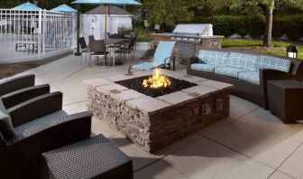 Sonesta ES Suites Cincinnati - Blue Ash’s patio area features a fire pit, plus tables and chairs, and a barbecue.