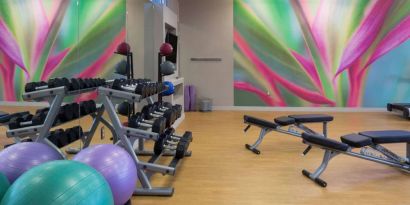 Sonesta Miami Airport’s fitness center is equipped with racks of free weights, multiple benches, and gym balls.