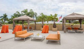 The hotel’s patio has comfortable sofa seating, coffee tables, and potted palm trees.