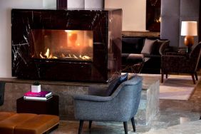 Royal Sonesta Washington DC Dupont Circle’s lobby lounge is furnished with comfortable seating, coffee tables, and a fireplace.