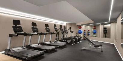 Sonesta Silicon Valley’s fitness center is equipped with assorted exercise machines, a bench, and gym balls.