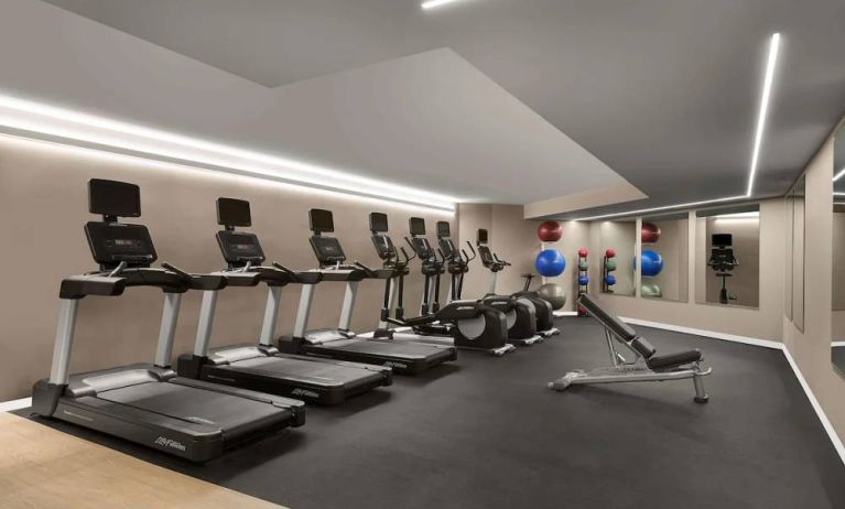 Sonesta Silicon Valley’s fitness center is equipped with assorted exercise machines, a bench, and gym balls.