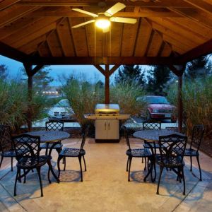 Sonesta Simply Suites Cleveland North Olmsted Airport’s gazebo has an overhead fan, barbecue, and tables and chairs.