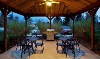 Sonesta Simply Suites Cleveland North Olmsted Airport’s gazebo has an overhead fan, barbecue, and tables and chairs.