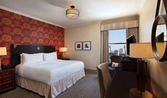 The Stephen F Austin Royal Sonesta Hotel double bed guest room, including window and workspace desk and chair.