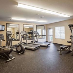 Sonesta Simply Suites Arlington’s fitness center is equipped with a widescreen TV and a range of exercise machinery.