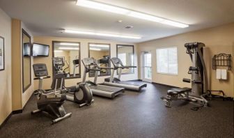 Sonesta Simply Suites Arlington’s fitness center is equipped with a widescreen TV and a range of exercise machinery.