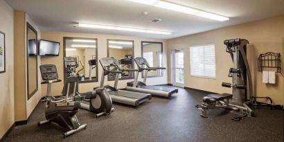 Sonesta Simply Suites Arlington’s fitness center is equipped with a widescreen TV and a range of exercise machinery.