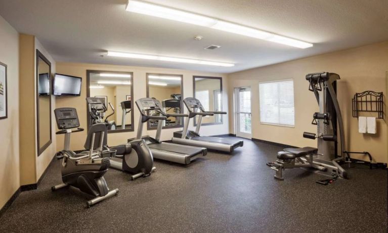 Sonesta Simply Suites Arlington’s fitness center is equipped with a widescreen TV and a range of exercise machinery.