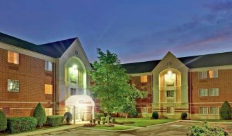 Sonesta Simply Suites Nashville Brentwood’s exterior is brightly lit and has well-tended lawns, bushes, and trees.