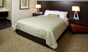 Sonesta ES Suites San Jose Airport double bed guest room, including bedside lamps and an ensuite bathroom.