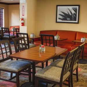 The hotel’s breakfast area has a mix of table sizes and both chairs and sofa seating.