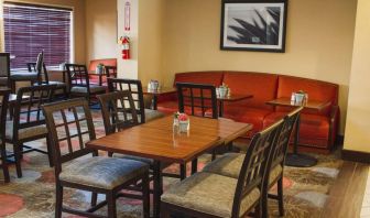 The hotel’s breakfast area has a mix of table sizes and both chairs and sofa seating.