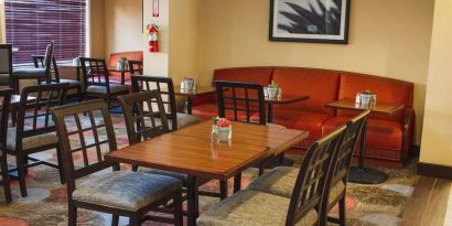 The hotel’s breakfast area has a mix of table sizes and both chairs and sofa seating.