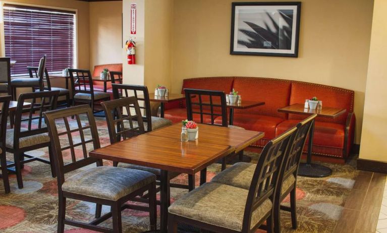 The hotel’s breakfast area has a mix of table sizes and both chairs and sofa seating.