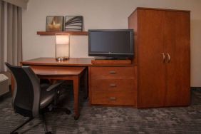 Sonesta Select Arlington Rosslyn guest room workspace, including desk, chair, lamp, and TV.