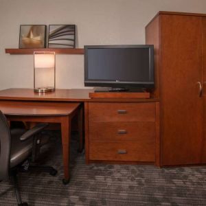 Sonesta Select Arlington Rosslyn guest room workspace, including desk, chair, lamp, and TV.