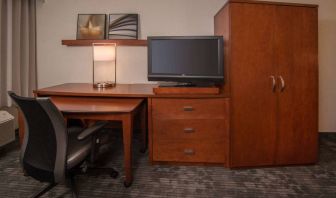 Sonesta Select Arlington Rosslyn guest room workspace, including desk, chair, lamp, and TV.