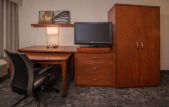 Sonesta Select Arlington Rosslyn guest room workspace, including desk, chair, lamp, and TV.