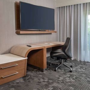 Sonesta Select Allentown Bethlehem Airport guest room workspace, including desk, chair, and huge television.