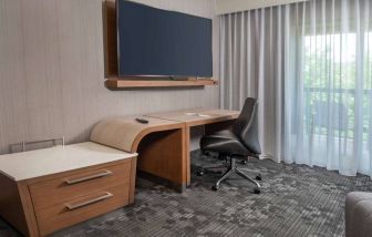 Sonesta Select Allentown Bethlehem Airport guest room workspace, including desk, chair, and huge television.