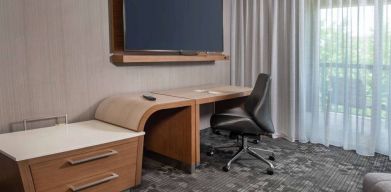 Sonesta Select Allentown Bethlehem Airport guest room workspace, including desk, chair, and huge television.