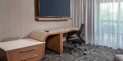 Sonesta Select Allentown Bethlehem Airport guest room workspace, including desk, chair, and huge television.