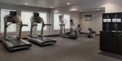 The hotel fitness center has an assortment of exercise machines and free weights.