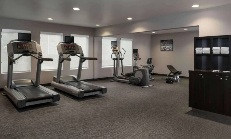 The hotel fitness center has an assortment of exercise machines and free weights.