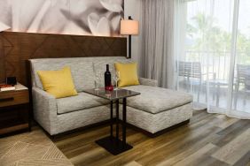 Guest room in Royal Sonesta Kaua'i Resort Lihue, featuring corner sofa, coffee table, and balcony.