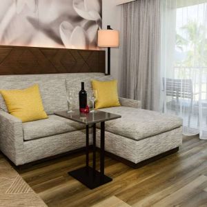 Guest room in Royal Sonesta Kaua'i Resort Lihue, featuring corner sofa, coffee table, and balcony.