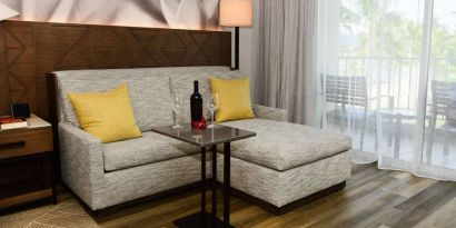 Guest room in Royal Sonesta Kaua'i Resort Lihue, featuring corner sofa, coffee table, and balcony.