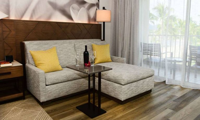 Guest room in Royal Sonesta Kaua'i Resort Lihue, featuring corner sofa, coffee table, and balcony.