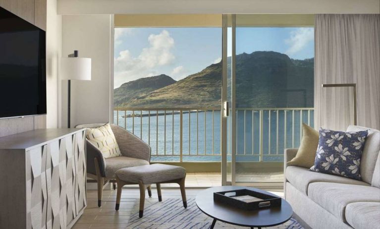 Royal Sonesta Kaua'i Resort Lihue guest room, furnished with sofa, coffee table, chair, and TV.