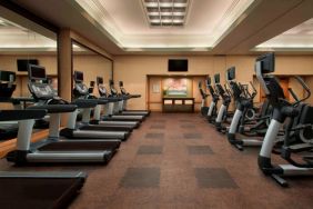 Royal Sonesta Kaua'i Resort Lihue’s fitness center has a large number of exercise machines and a wall-mounted widescreen television.