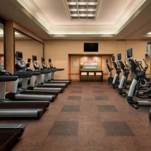 Royal Sonesta Kaua'i Resort Lihue’s fitness center has a large number of exercise machines and a wall-mounted widescreen television.