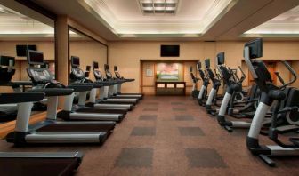 Royal Sonesta Kaua'i Resort Lihue’s fitness center has a large number of exercise machines and a wall-mounted widescreen television.