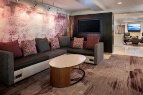 The hotel’s lobby has comfortable sofa seating, a coffee table, and large widescreen television.