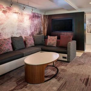 The hotel’s lobby has comfortable sofa seating, a coffee table, and large widescreen television.