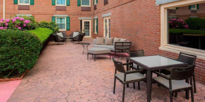 Sonesta Select Boston Lowell Chelmsford’s patio has a mix of sofa seating and chairs, plus coffee tables.