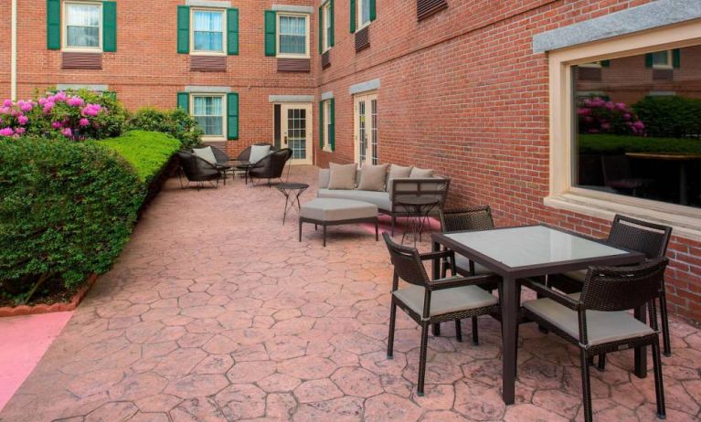 Sonesta Select Boston Lowell Chelmsford’s patio has a mix of sofa seating and chairs, plus coffee tables.