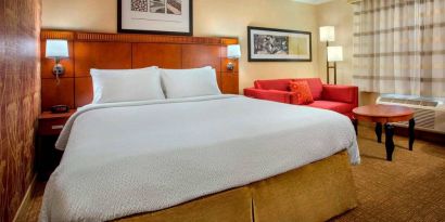 Double bed guest room in Sonesta Select Boston Danvers, furnished with sofa and coffee table.