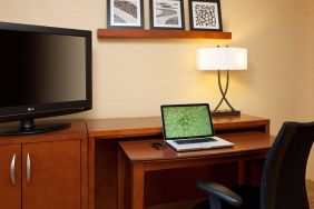 Sonesta Select Boston Danvers guest room workspace, including desk, chair, lamp, and TV.