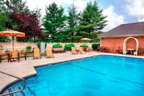 Sonesta Select Boston Danvers’ outdoor pool has sun loungers by the side, in addition to shaded tables and chairs.