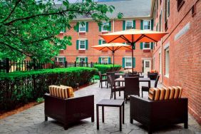 The hotel’s patio has armchairs and coffee tables, plus shaded tables and chairs.