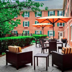 The hotel’s patio has armchairs and coffee tables, plus shaded tables and chairs.