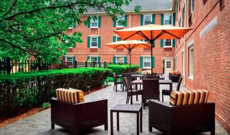 The hotel’s patio has armchairs and coffee tables, plus shaded tables and chairs.