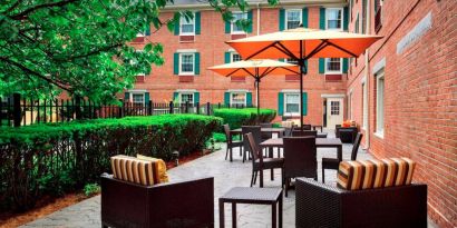 The hotel’s patio has armchairs and coffee tables, plus shaded tables and chairs.