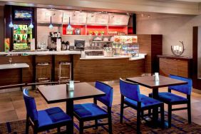 Breakfast area in Sonesta Select Boston Danvers, with seating at small tables or tall bar stools, and a range of healthy options.