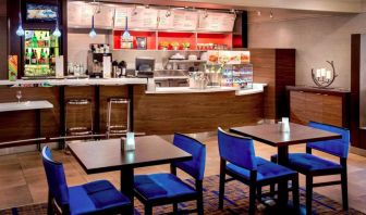 Breakfast area in Sonesta Select Boston Danvers, with seating at small tables or tall bar stools, and a range of healthy options.